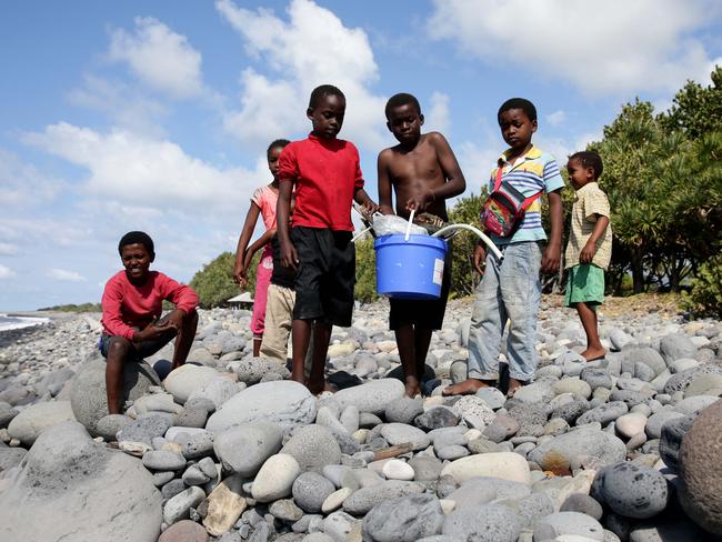 Hope ... Many locals, including children, spend spare time on the beach searching for washed-up debris in case it’s from Flight MH370. Picture: Cameron Richardson