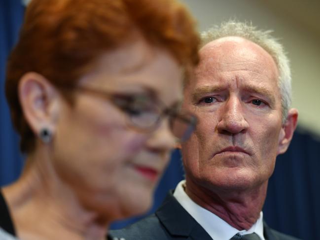 Queensland Senator and One Nation leader Pauline Hanson is watched by party official Steve Dickson during the press conference.