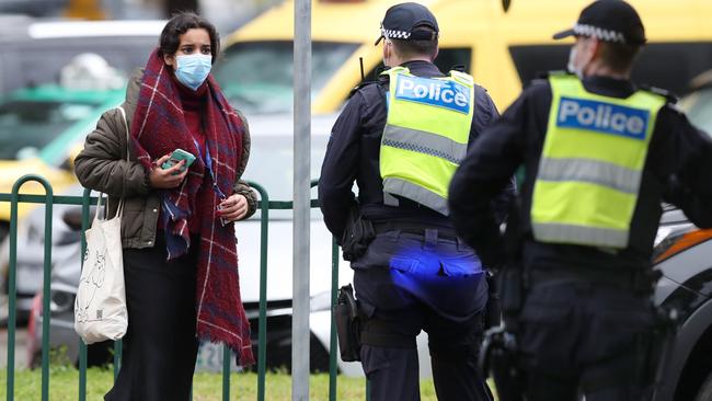 Police continue to monitor a lockdown at the Flemington housing towers. Picture: David Crosling