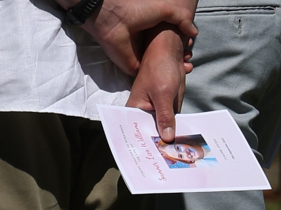 A mourner holds the order of service. Picture: John Grainger