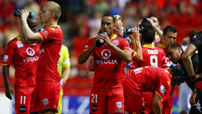 Adelaide United players take a drinks break in the heat. Picture: Sarah Reed.