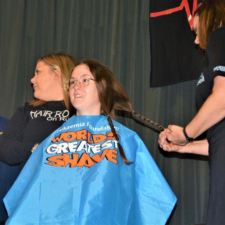 At the St Joseph's College 2023 World's Greatest Shave event is student Georgie Hansen getting her hair cut by hairdressers (from left) Georgie Harwood and Jillian Grundy. Picture: Rhylea Millar