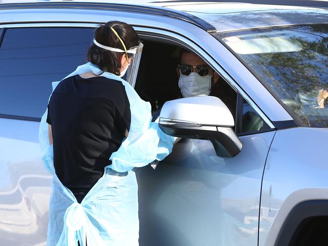 PERTH, AUSTRALIA - FEBRUARY 01: Members of the public attend the Rivervale drive thru Covid-19 testing clinic on February 01, 2021 in Perth, Australia. Lockdown restrictions are now in place across the Perth, Peel and South West regions of Western Australia following the discovery of a positive community COVID-19 case in a worker from a quarantine hotel facility.  As of 6pm on Sunday, people Perth, Peel and the South West are subject to stay at home orders, and will only be allowed to leave their homes to shop for essentials, for medical or health needs, exercise within their neighbourhood or travel to work if they cannot work from home. Face masks are now mandatory outdoors, with all restrictions to remain in place until 6pm on February 5. (Photo by Paul Kane/Getty Images)