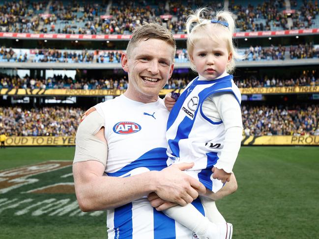 MELBOURNE, AUSTRALIA - AUGUST 19: Jack Ziebell of the Kangaroos and daughter Pippa embrace after his final match during the 2023 AFL Round 23 match between the Richmond Tigers and the North Melbourne Kangaroos at Melbourne Cricket Ground on August 19, 2023 in Melbourne, Australia. (Photo by Michael Willson/AFL Photos via Getty Images)