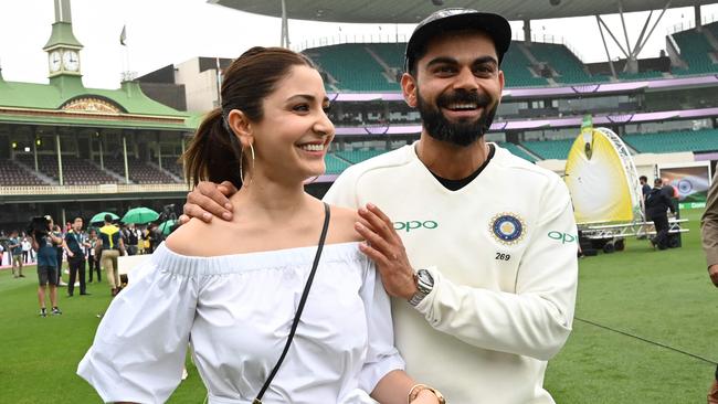 Virat Kohli and his wife Anushka Sharma walk on the field as they celebrate India's series win on the fifth day of the fourth and final cricket Test against Australia at the Sydney Cricket Ground. Picture: Peter Parks/AFP