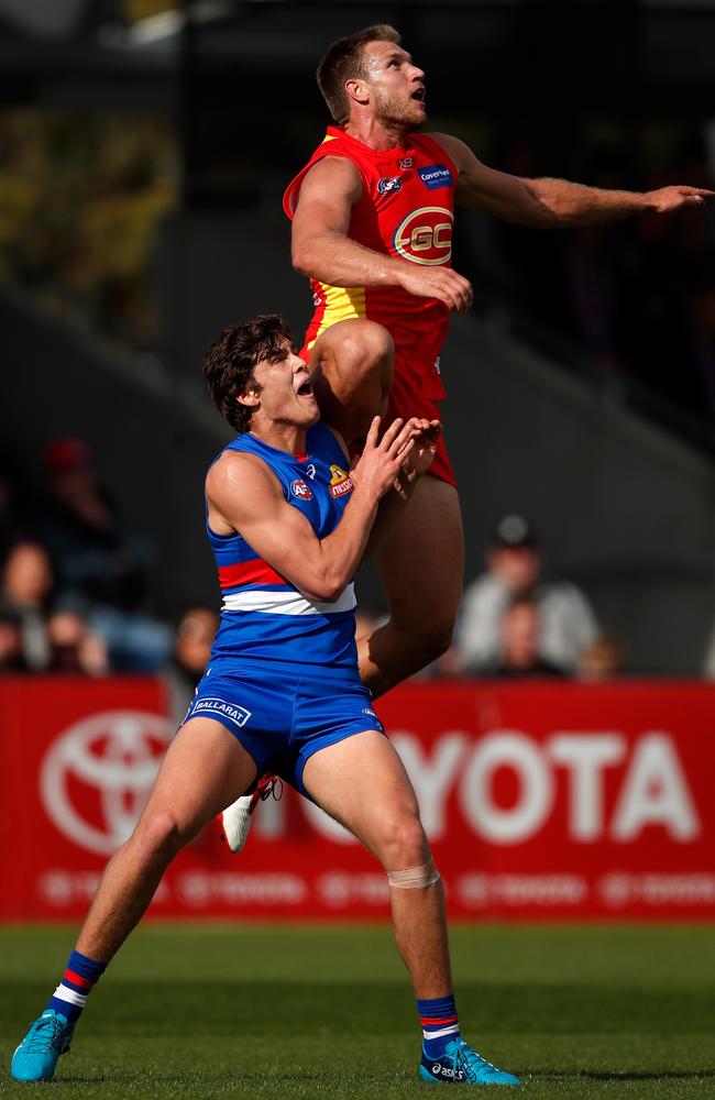 Sam Day attempts to mark over Lewis Young.