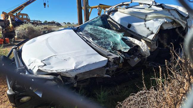 The totalled stolen car in a holding yard after being towed away from the crash scene.