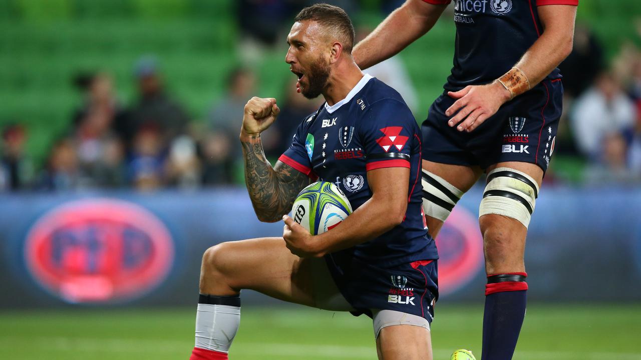 Quade Cooper of the Rebels celebrates after scoring a try.