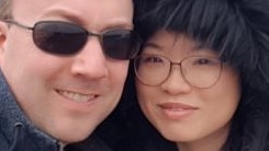 Lecturer Adam Brown is in custody after his wife was stabbed to death at home.