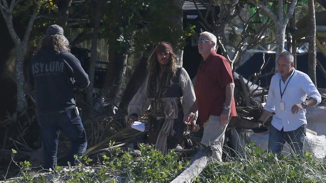 Hollywood superstar Johnny Depp, surrounded by bodyguards, walks to the Pirates of the Caribbean set at the Doug Jennings Park on The Spit in Broadwater, Gold Coast. Picture: Regi Varghese