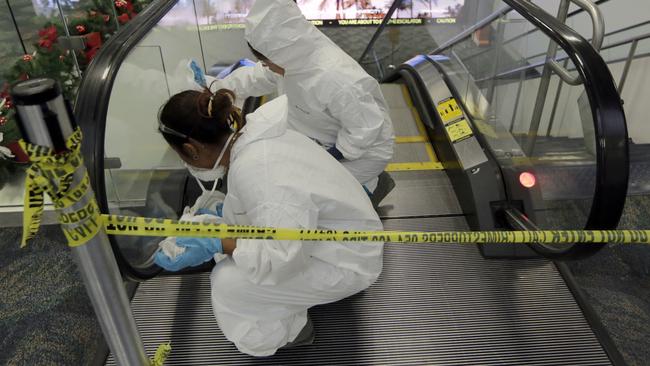 Workers clean the escalators that lead to the baggage claim area at terminal 2 at the Fort Lauderdale after a gunman opened fire at the facility on Friday. Picture: AP