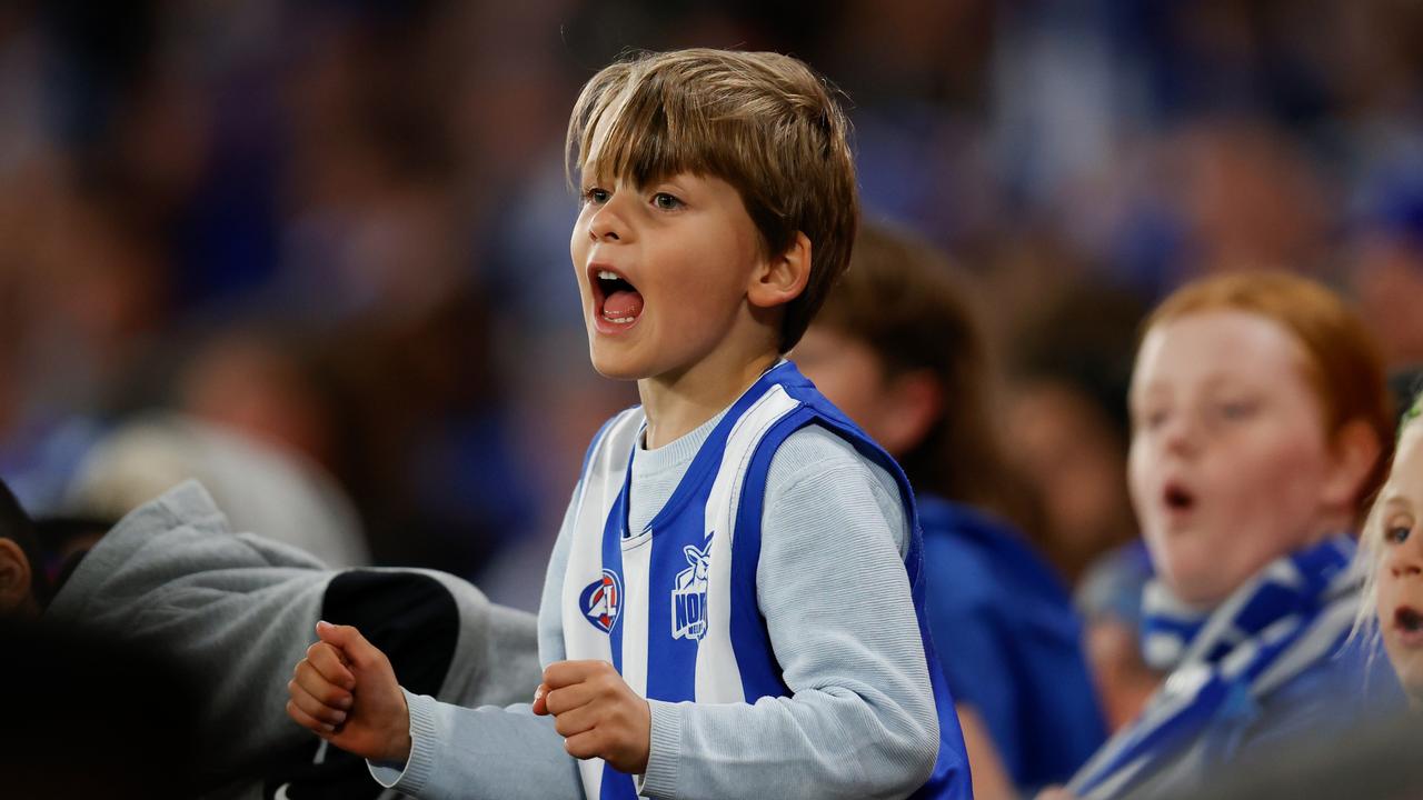 A young Roos fan cheers North Melbourne on.