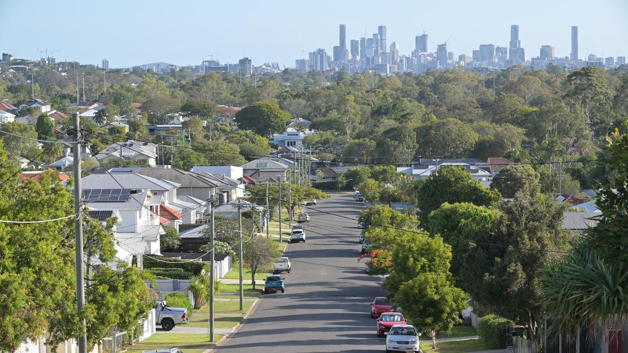 Brisbane - Nov 18 2023:Residential houses street against Brisbane City skyline.Home prices across Australia have hit new highs, with the median value of a home in a capital city shooting to $832,000. housing suburbs generic