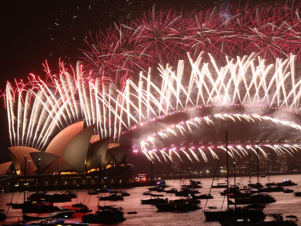 The harbour bridge lights up for the Midnight fireworks display, New Years Eve Fireworks on the Sydney Harbour Bridge as seen from Mrs Macquarie's Point 2019. Picture Rohan Kelly