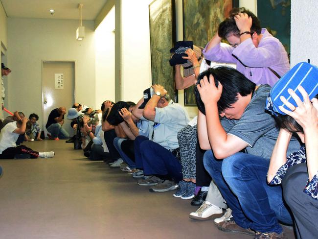 Residents cover their heads while taking shelter during an evacuation drill for North Korean missiles in Wajima, Ishikawa prefecture one day after a missile passed over Japan. Picture: AFP/JIJI PRESS