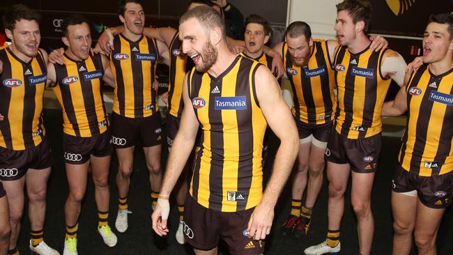 Kurt Heatherley sings the song after playing in his first win for Hawthorn. Picture: Michael Klein