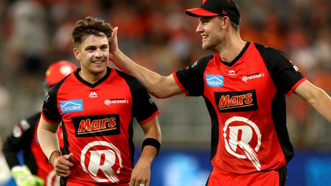 Cameron Boyce (left) of the Renegades is congratulated by Beau Webster after dismissing Nick Hobson of the Scorchers.