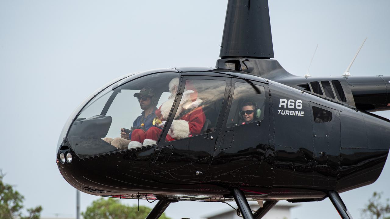 Santa’s descent by helicopter into Casuarina Square was watched by dozens of excited children and adults. Picture: Pema Tamang Pakhrin