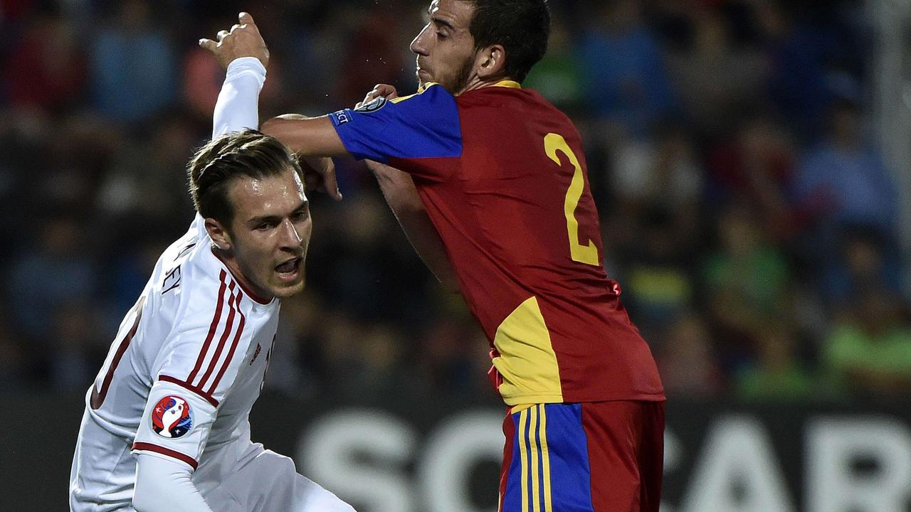 Andorra defender Cristian Martinez (R) vies with Wales forward Aaron Ramsey during the Euro 2016 qualifying round football match Andorra vs Wales on September 9, 2014 at the Municipal Stadium in Andorra. AFP PHOTO / PASCAL PAVANI
