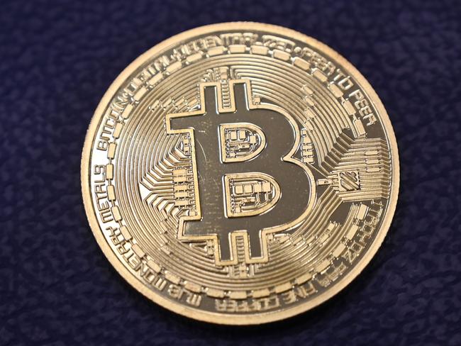 This photograph taken on December 17, 2020 shows shows a physical imitation of a Bitcoin at a crypto currency "Bitcoin Change" shop, near Grand Bazaar, in Istanbul. - Leading virtual currency bitcoin on 16 December traded above $20,000 for the first time following a sustained run higher in recent weeks. Bitcoin reached a record-high $20,398.50 before pulling back to $20,145, which was still an intra-day gain of nearly four percent. (Photo by Ozan KOSE / AFP)