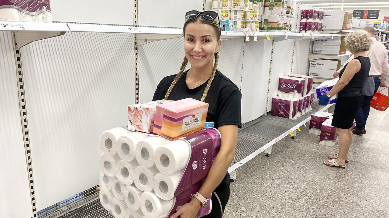 Nathalie Agirre grabs some toilet paper at Coles New Farm in Brisbane. Picture: Richard Gosling/AAP