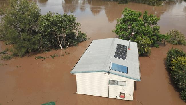 A house is seen surrounded by flood waters from the Mary River in the town of Tiaro, on Sunday, January 9, 2022. The town, between Gympie and Maryborough, is still recovering from the unprecedented floods. (AAP Image/Darren England).