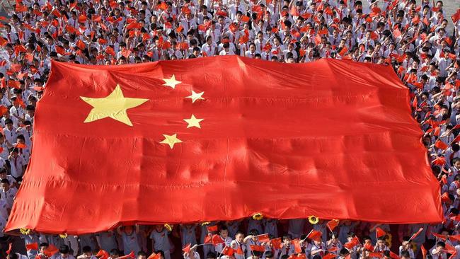 School students hold a giant Chinese flag in Handan, Hebei province. Picture: China Stringer Network/Reuters