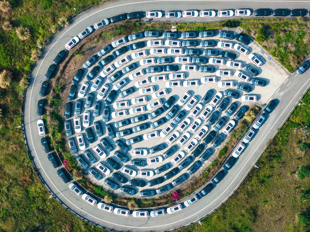 New electric cars for sale are seen parked at a distribution centre of the Changan car company in China. Picture: AFP