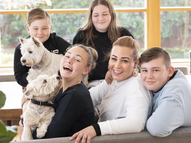 Alexandra Johnson with children, clockwide from front left, Scarlett, 14, Atticus, 9, Avalon, 10, and Archie, 12, with the family’s pet dogs. Picture Eddie Safarik