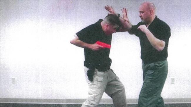 Police ‘shove and shoot’ training in response to a simulated attack from an edged weapon. Picture: Courts NT