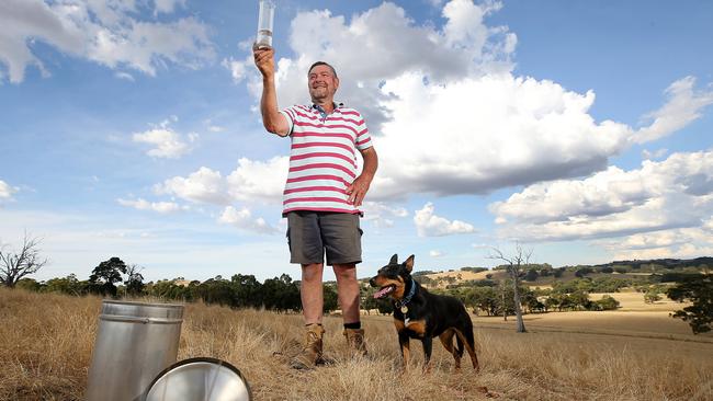 Alistair Lade, Highlands, with rain gauge and his dog Rose. Picture: Yuri Kouzmin