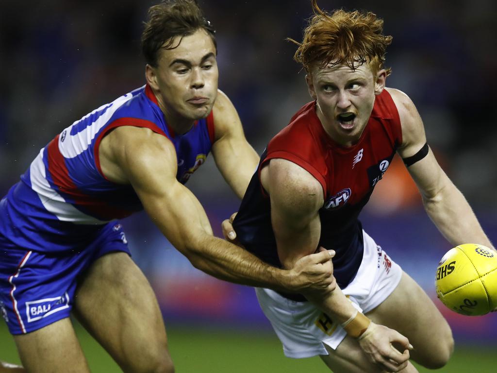 Jake Bowey handpasses the ball under pressure from Lachlan McNeil. Picture: Getty Images