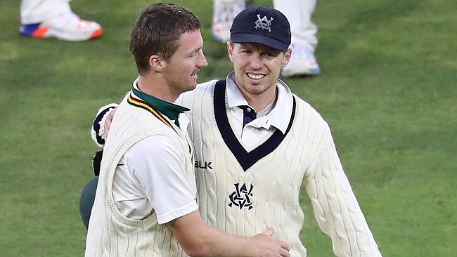 Victorian paceman (right) with Tasmania’s Jackson Bird at the end of their Sheffield Shield match on Friday night.