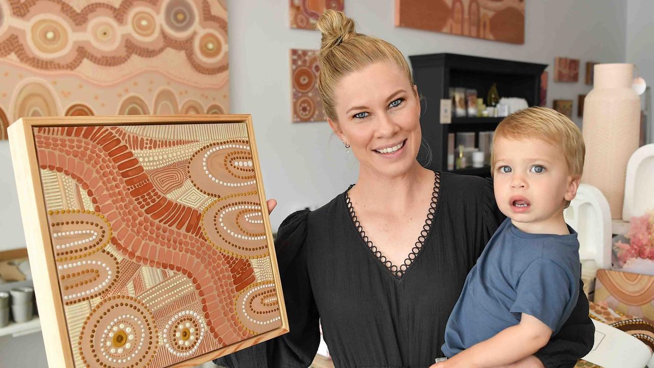 Domica Hill, pictured with her son Jyka, displays her artwork at her store that opened on October 15, 2022. Photo: Patrick Woods.