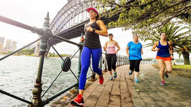 Group of women running by Sydney Harbour.