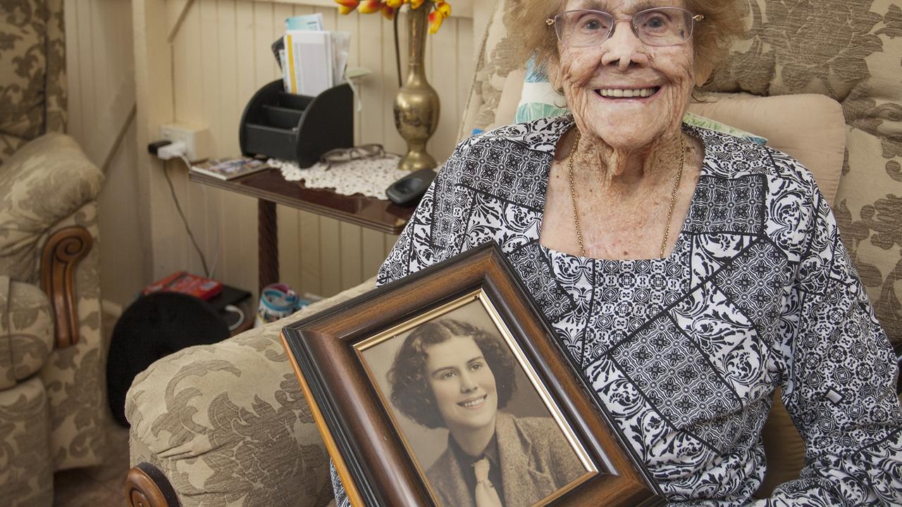 Cecilia Hynes of Maryborough, at 102 years of age, holding a photograph of herself when she was aged 18 years.