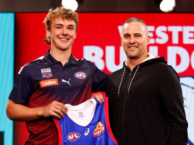 MELBOURNE, AUSTRALIA - NOVEMBER 20: Ryley Sanders is presented his Western Bulldogs guernsey by former player Lindsay Gilbee after the club picked him at no.6 in Monday’s draft. (Photo by Michael Willson/AFL Photos via Getty Images)