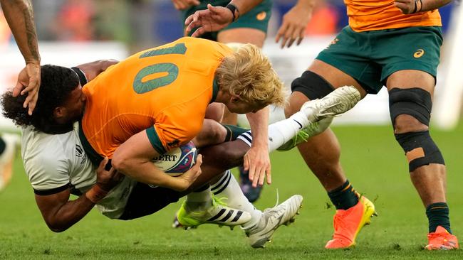 Australia's fly-half Carter Gordon (C) was worked over by Fiji. Picture: AFP