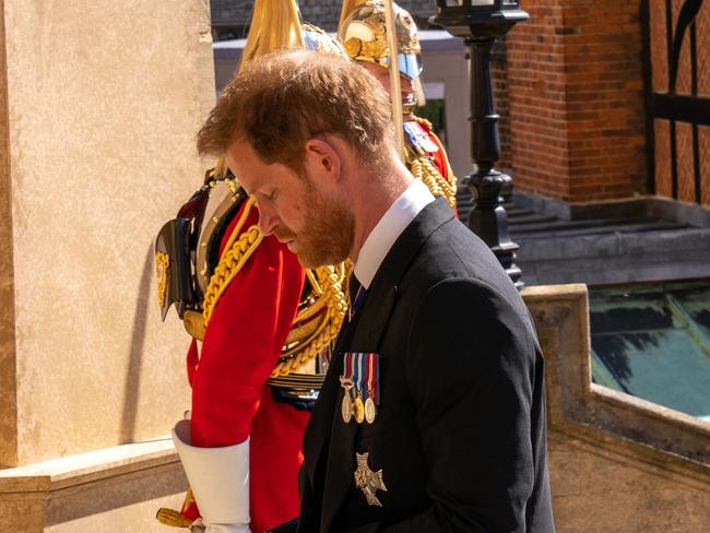 A sombre Prince Harry enters the chapel. Picture: AFP