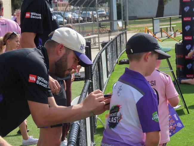 Caleb Jewell signs an autograph for a Hurricanes fan at Tuesday's fan day in Launceston. Picture: Jon Tuxworth