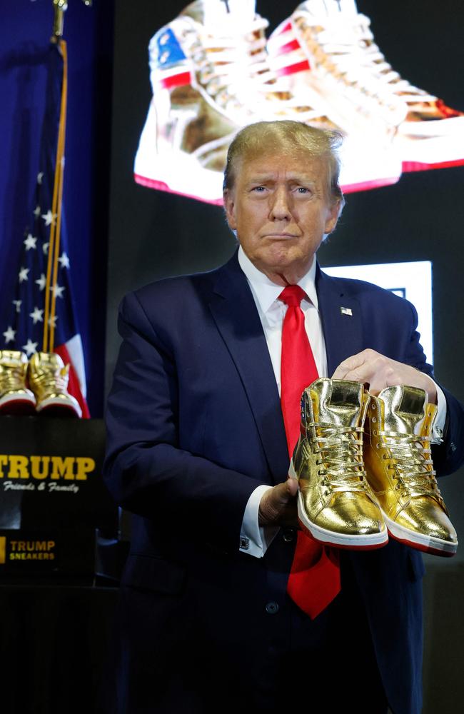 Republican presidential candidate and former President Donald Trump holds a pair of his new line of signature shoes. Picture: Getty Images/AFP