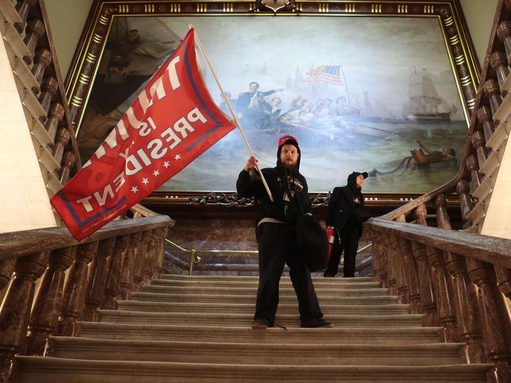 A protester holds a Trump flag inside the US Capitol Building near the Senate Chamber. Picture: Getty