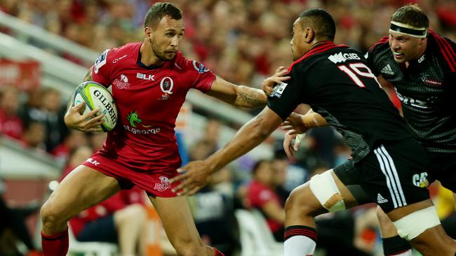 Quade Cooper fends off a Crusaders defender. Picture: Mark Calleja