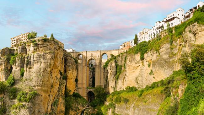 New bridge (Puente Nuevo) and the famous white houses on the cliffs in the city Ronda, Andalusia, Spain.