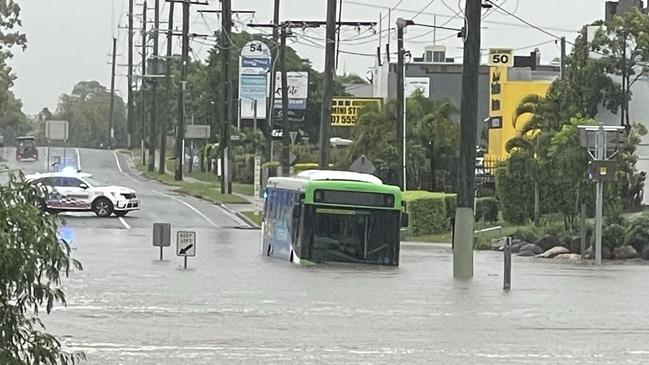 A bus has been swept up in flood waters on the Northern Gold Coast. Picture: Charlton Hart