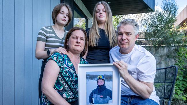 Tamara and Ben McKenzie, with daughters Ella and Lucy, hold a photo of their son Max, who died when he was just 15. Dr McKenzie says Victoria has ‘nothing to stop another Bacchus Marsh’ baby scandal after he was forced to report their own’s son death to SCV. Picture: Jake Nowakowski