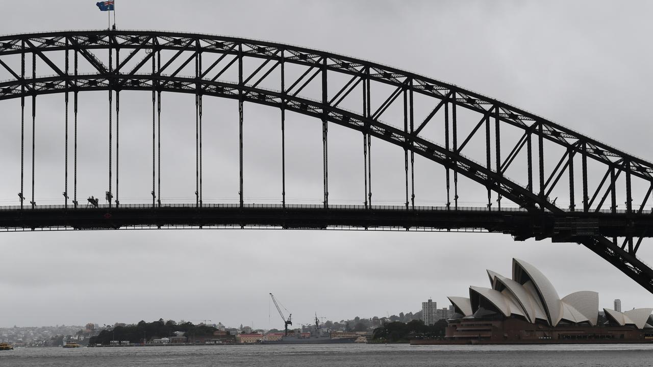 The flags on the Harbour Bridge blow in strong winds today in Sydney. Picture: James D. Morgan/Getty Images