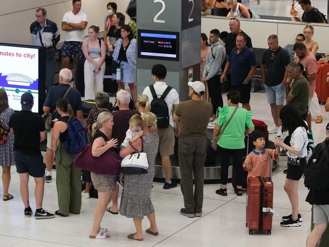 SYDNEY, AUSTRALIA - Newswire Photos MARCH 07 2023: A general view of people seen waiting for luggage as a shortage of Air Traffic controllers at Sydney Airport has caused one third of flights to be delayed. Picture: NCA Newswire / Gaye Gerard