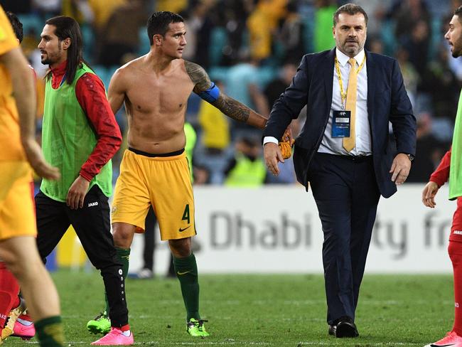 Australia's Tim Cahill with coach Ange Postecoglou after Socceroos’ victory over Syria