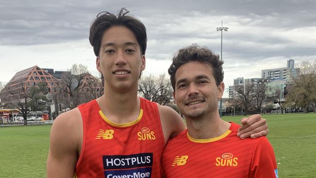 Cairns juniors and Gold Coast Suns players Alex Davies and Jarrod Harbow at a Suns training session.